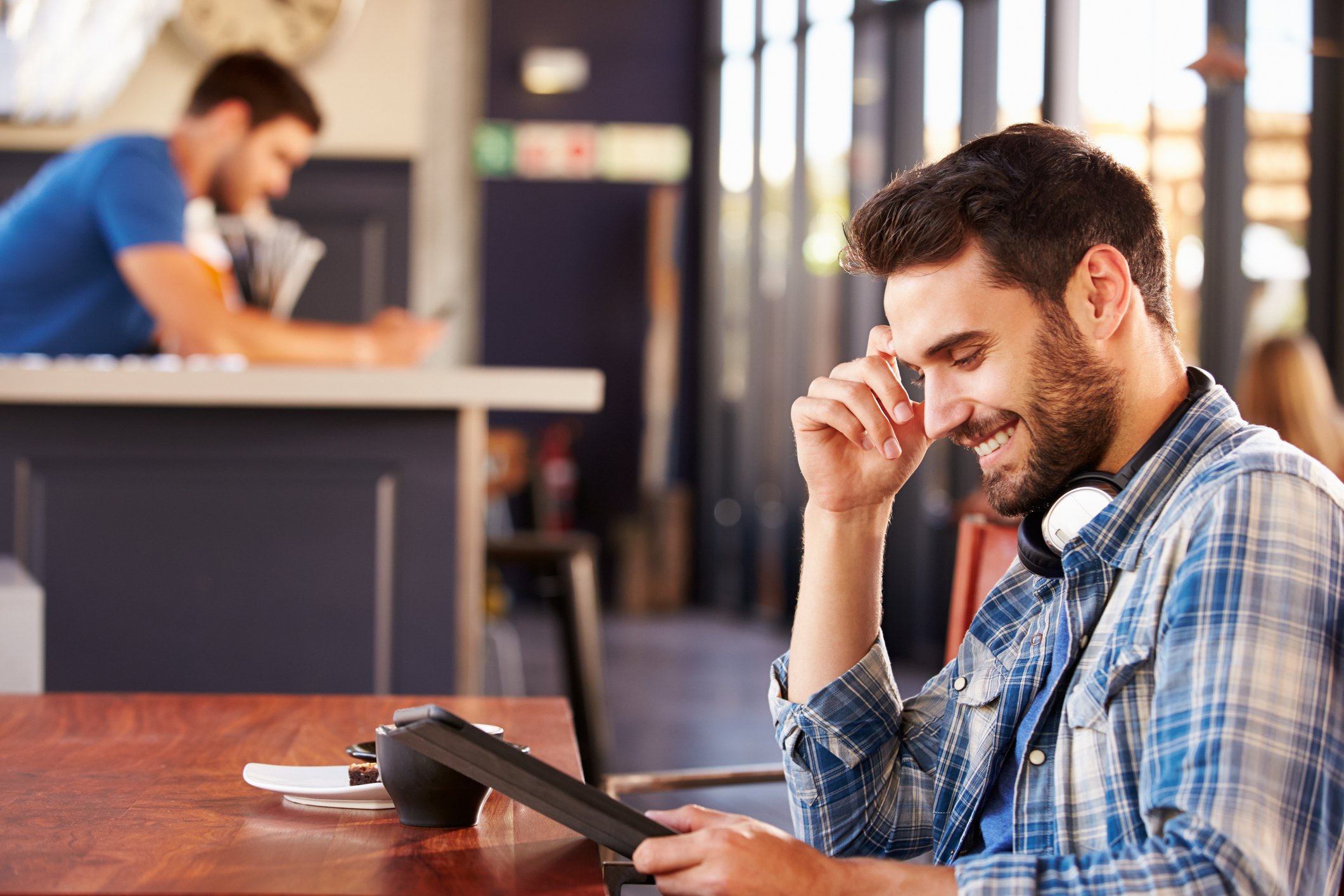 Man using tablet smiling