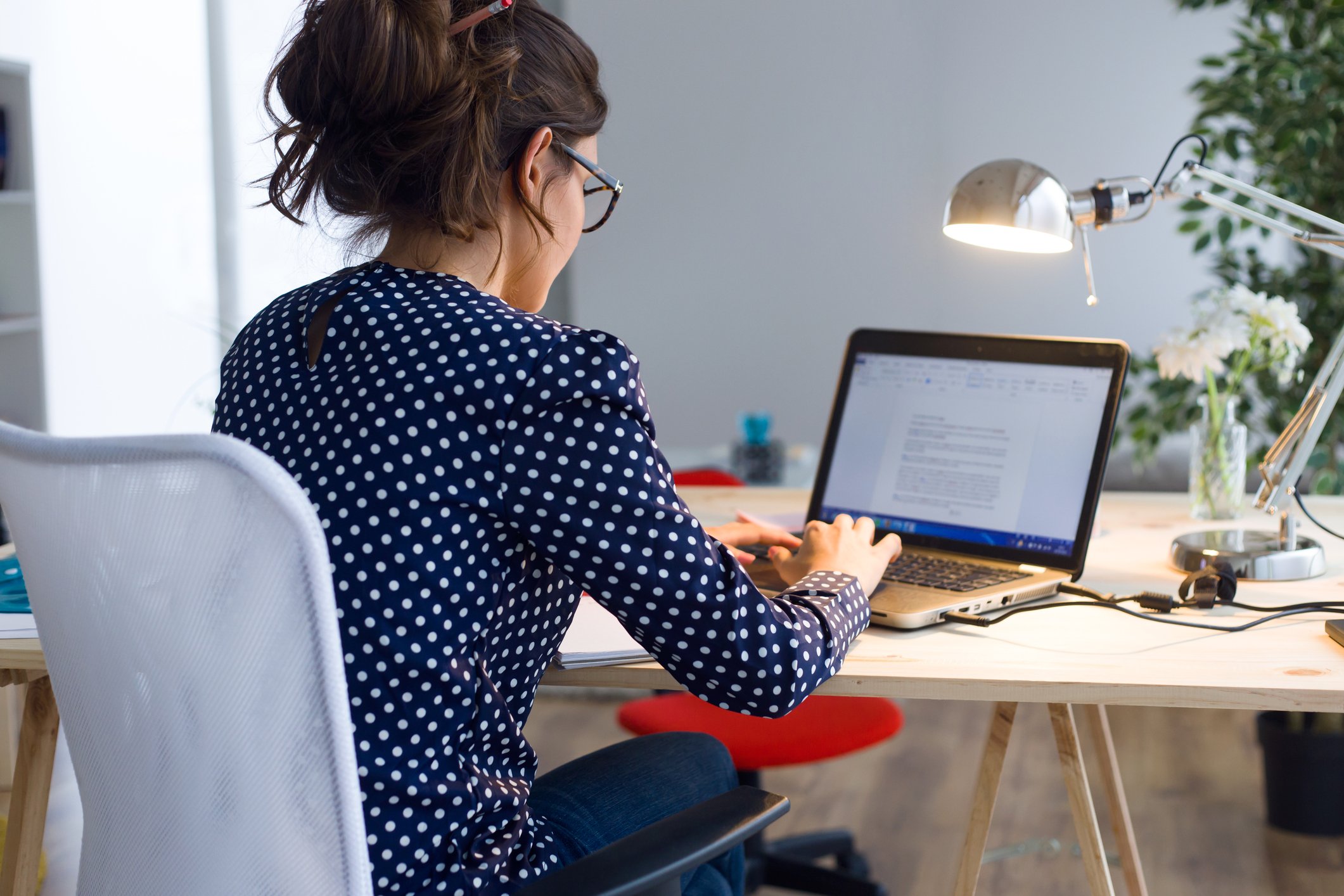 Woman writing blogs on her laptop