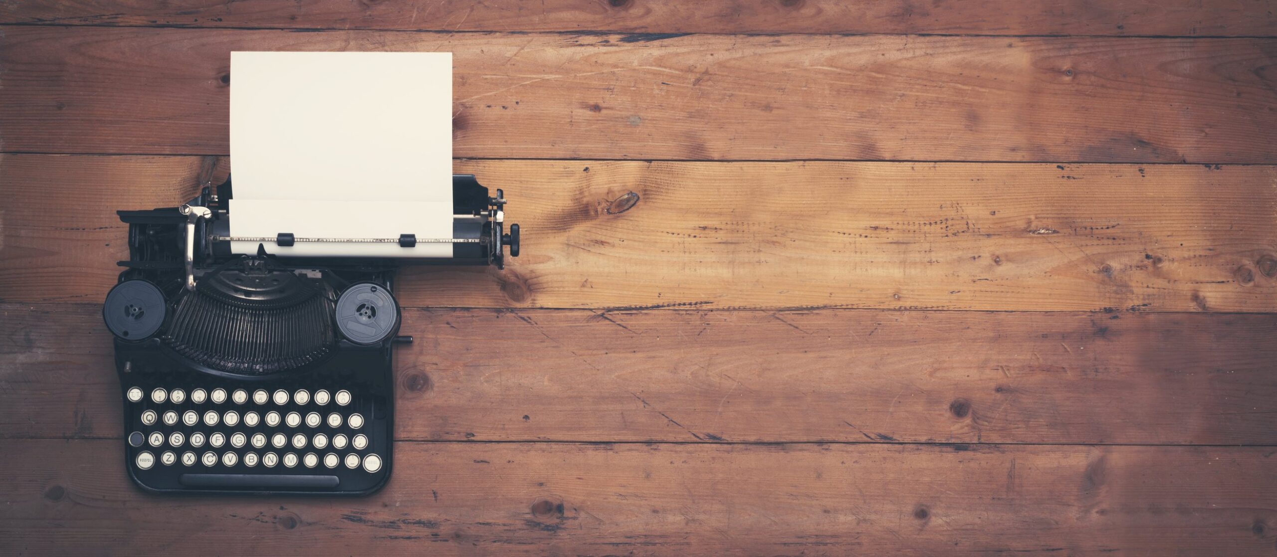 typewriter on wooden desk