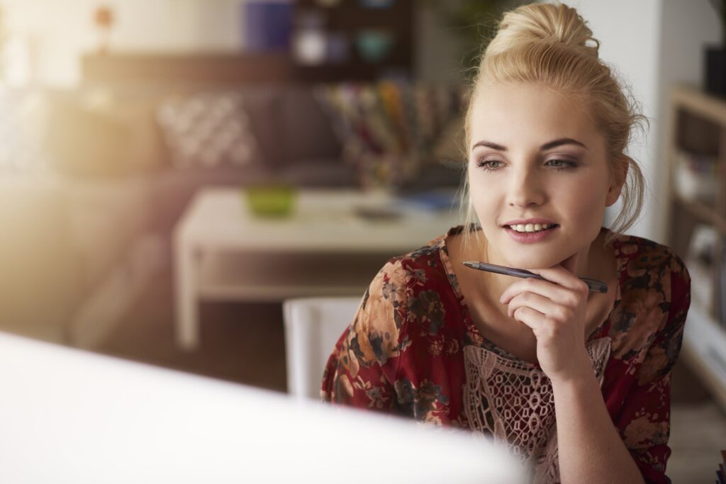 Young creative woman working at home