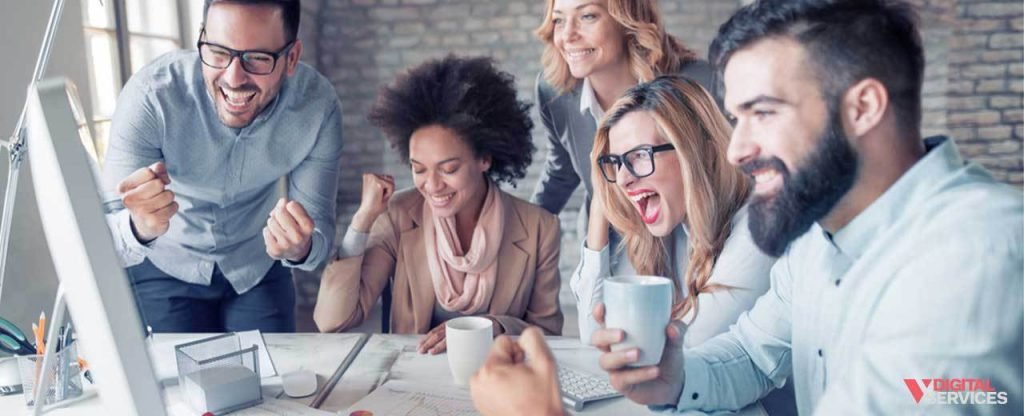 Photo of people working together on a project in an office