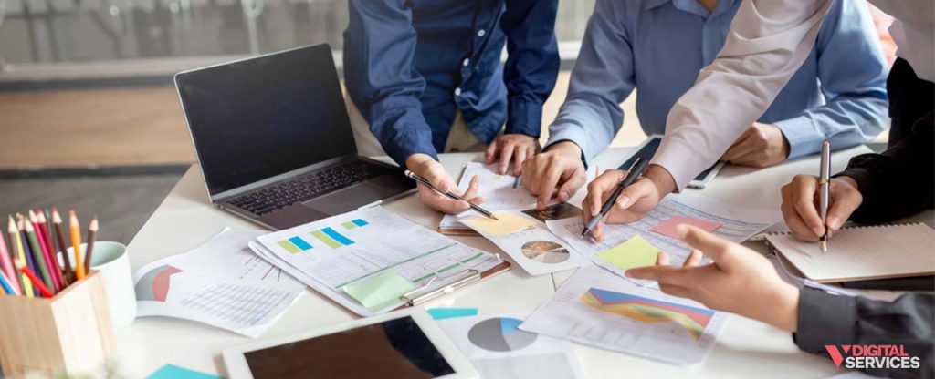 people in an office working together on a visual project